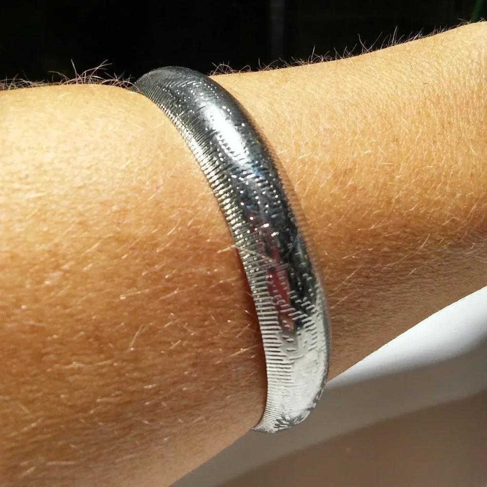 Women`s silver tone etched bangle bracelet. 2 3/4